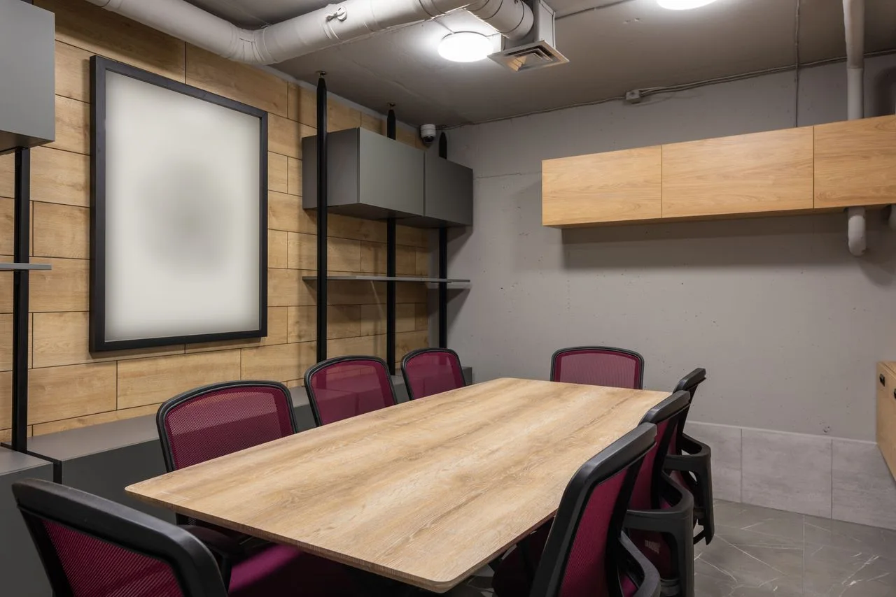 An illustrative office meeting room with a table and chairs