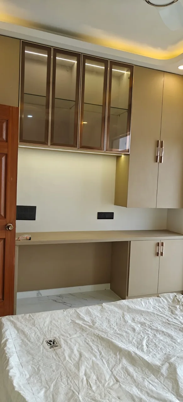 Tall storage and a built-in desk in a light neutral finish